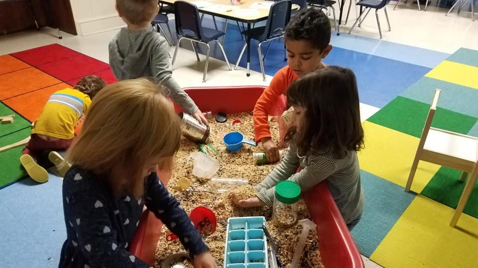 Children playing in a sensory bin