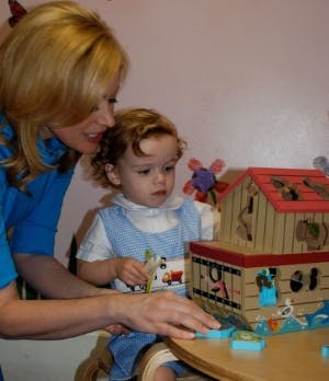 Adult and child playing with a toy ark
