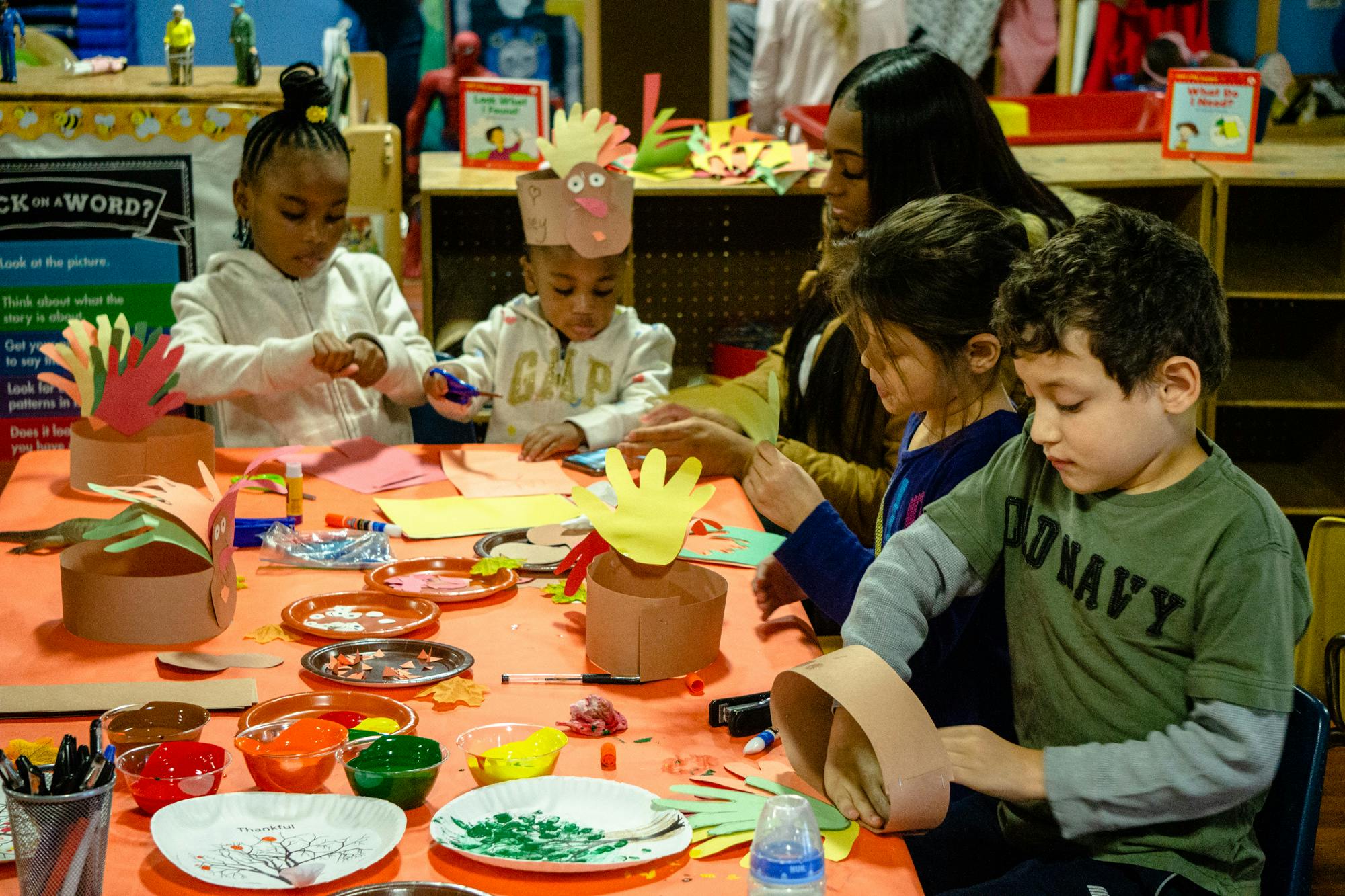 Adult and children doing crafts at a table