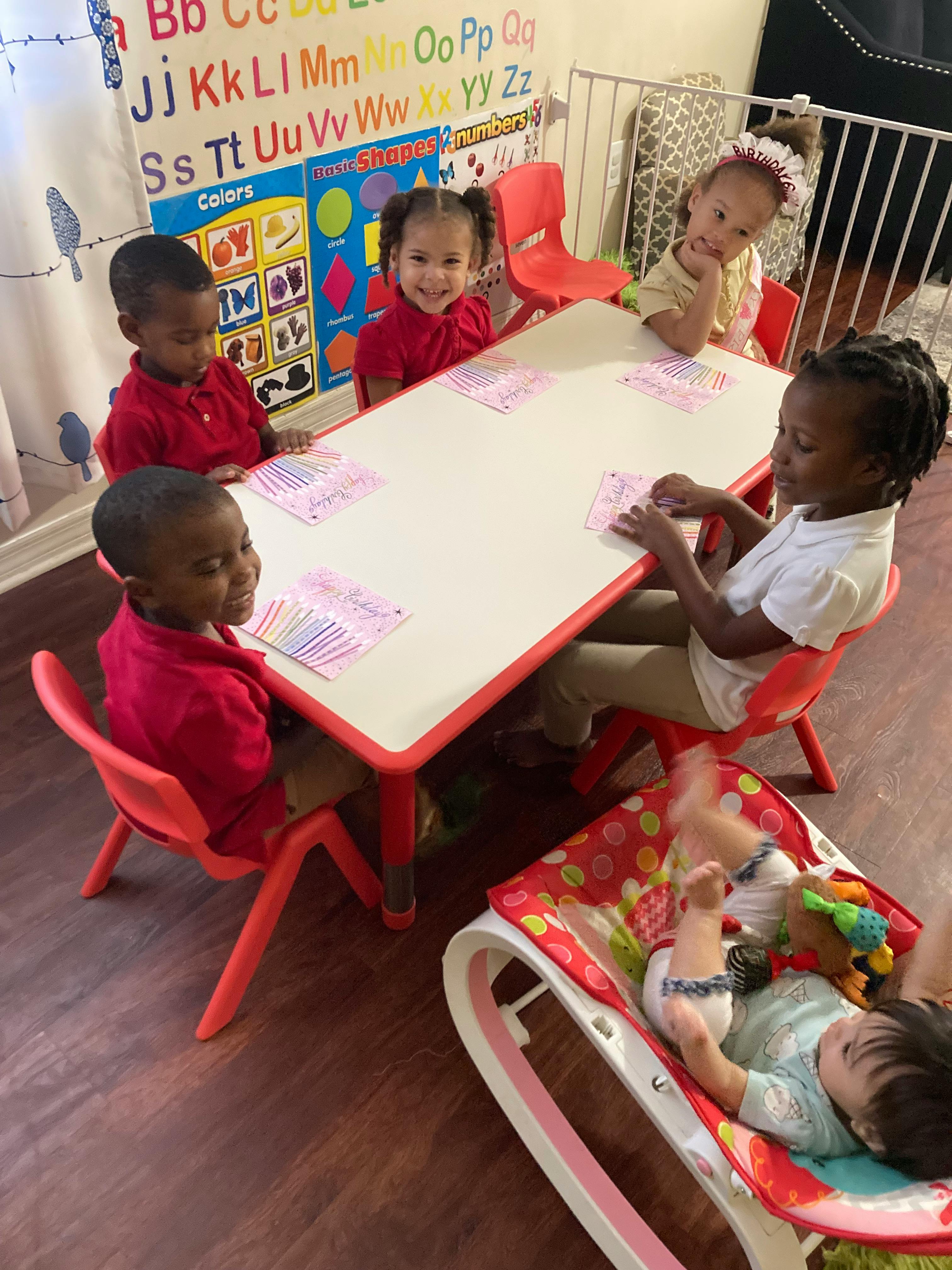 Group of children at a table with birthday cards