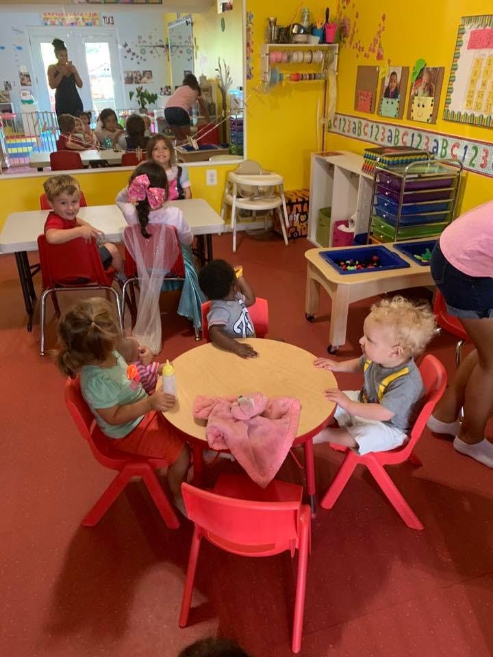 Children sitting at tables in a classroom