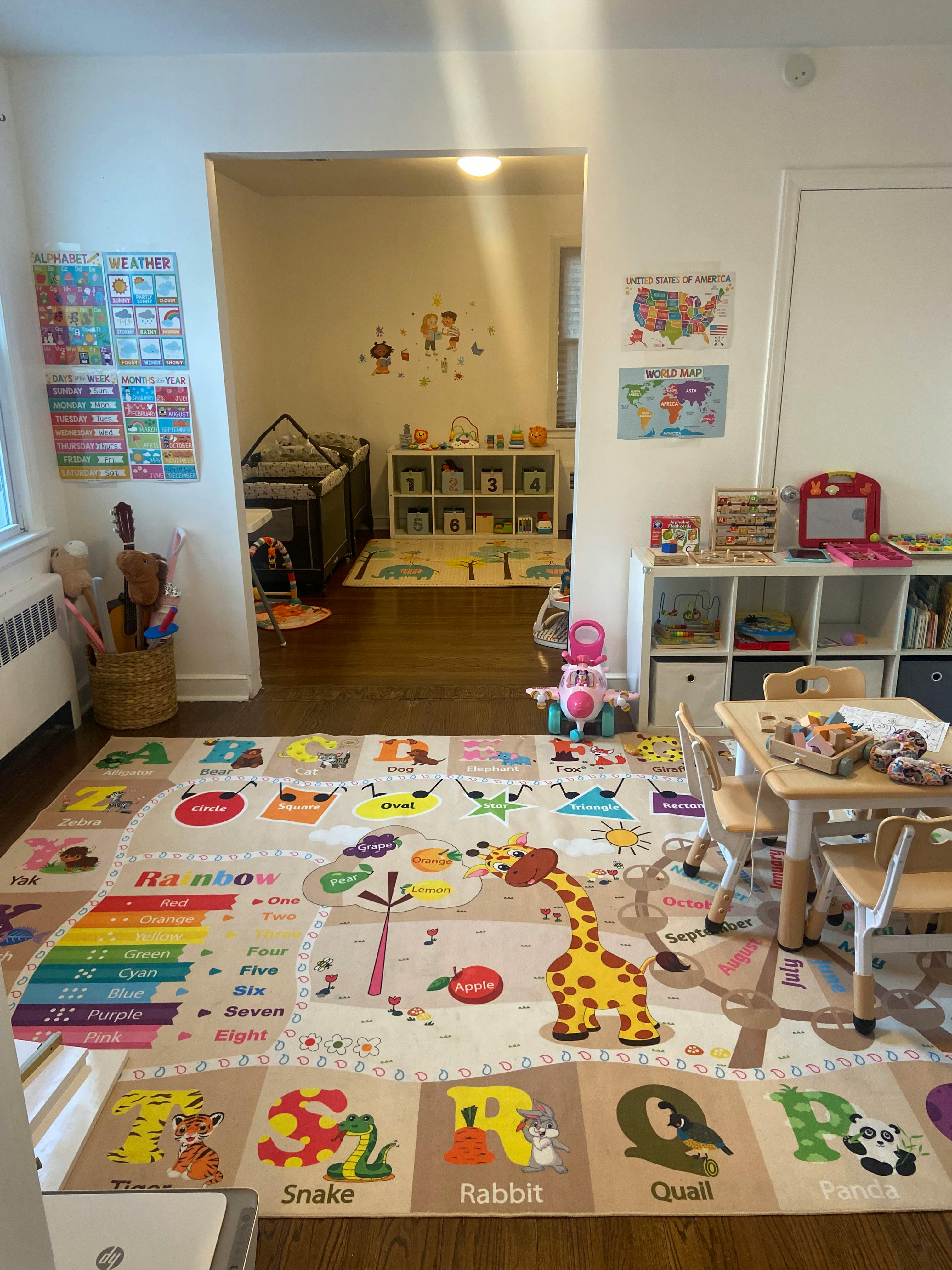 Playroom with a colorful alphabet and number rug, small table and chairs