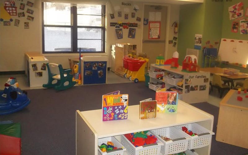 Classroom filled with toys, books, and children's furniture