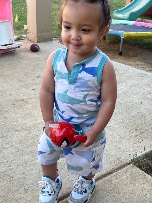 Child holding a red toy