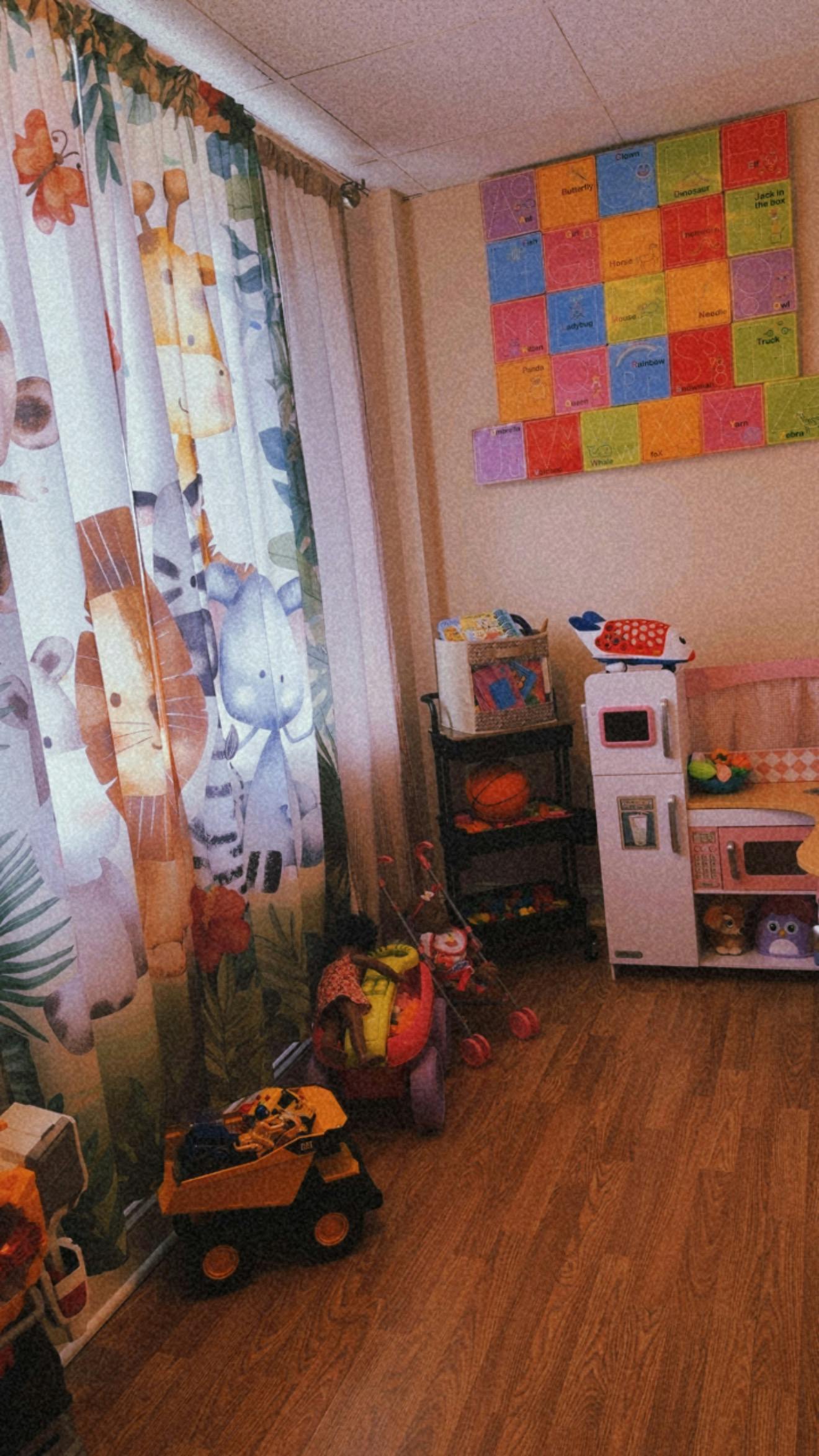 Playroom with animal print curtains and a colorful alphabet wall display