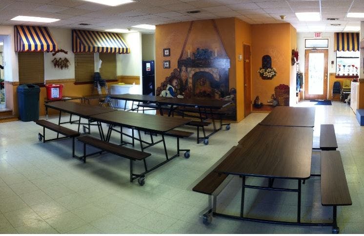 Empty cafeteria with long tables and benches