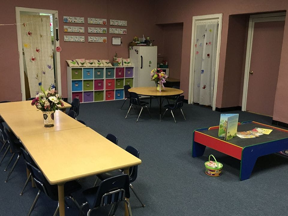 Classroom with tables, chairs, and storage cubbies