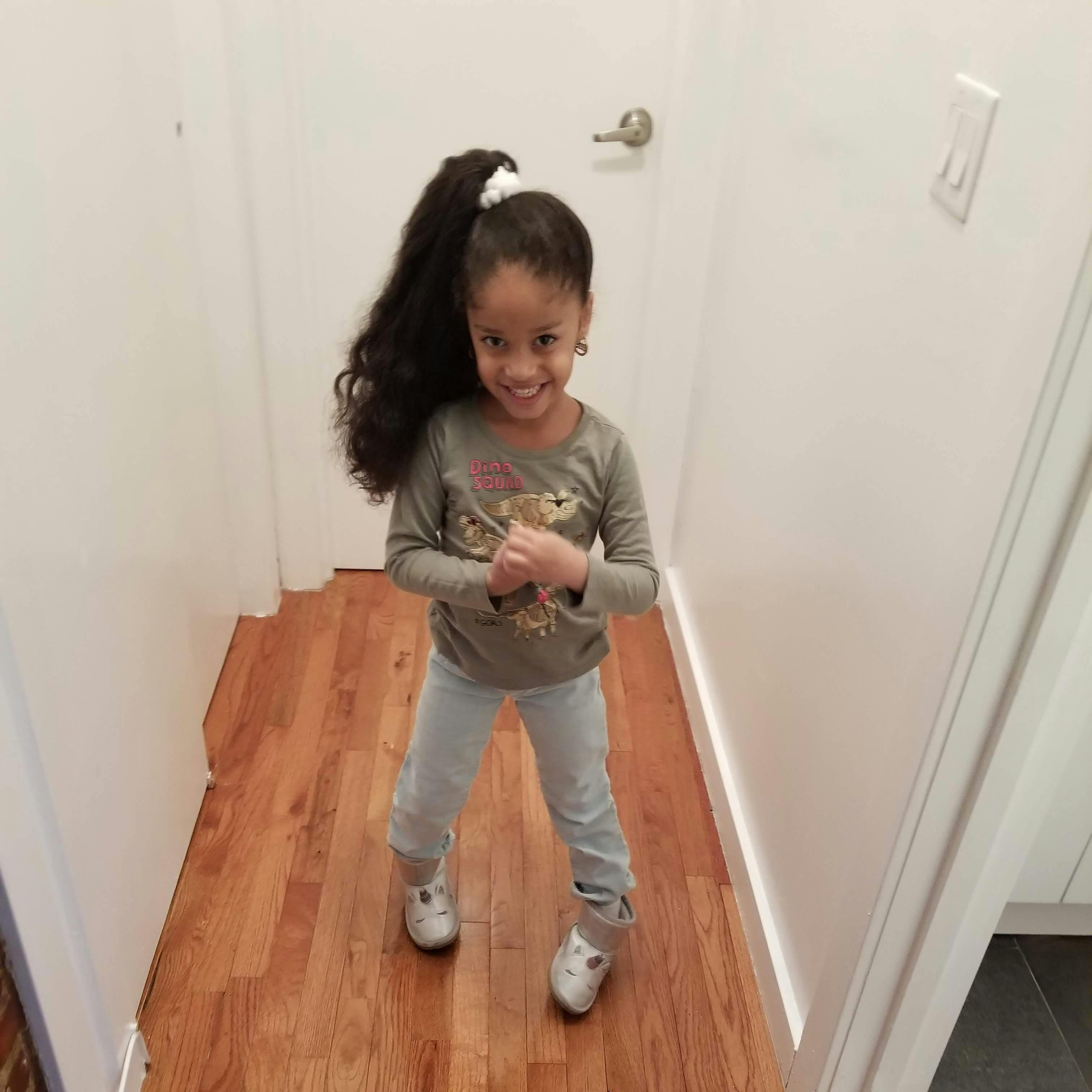 Child standing in a hallway