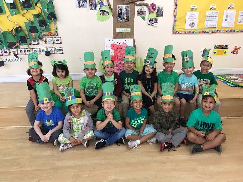 Group of children wearing green hats