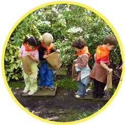 Four children holding bags outdoors
