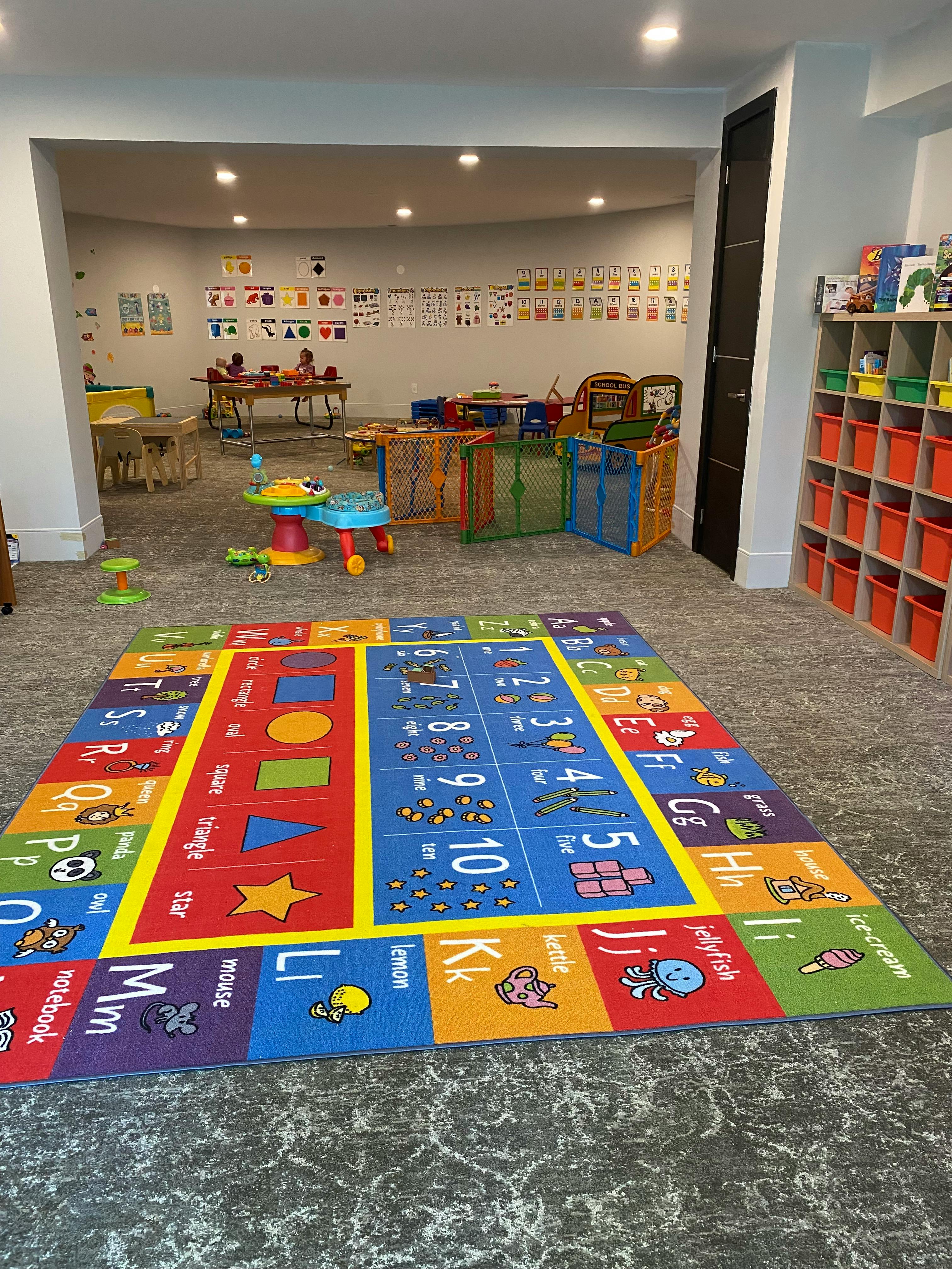 Playroom with a colorful alphabet and numbers rug