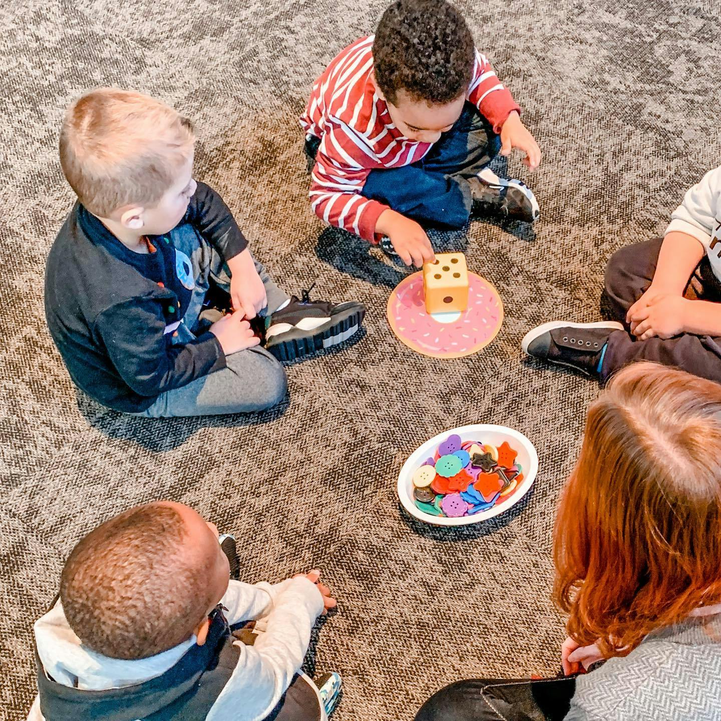 Children playing a board game on the floor