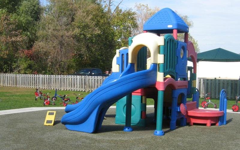 Colorful plastic playground structure with a blue slide