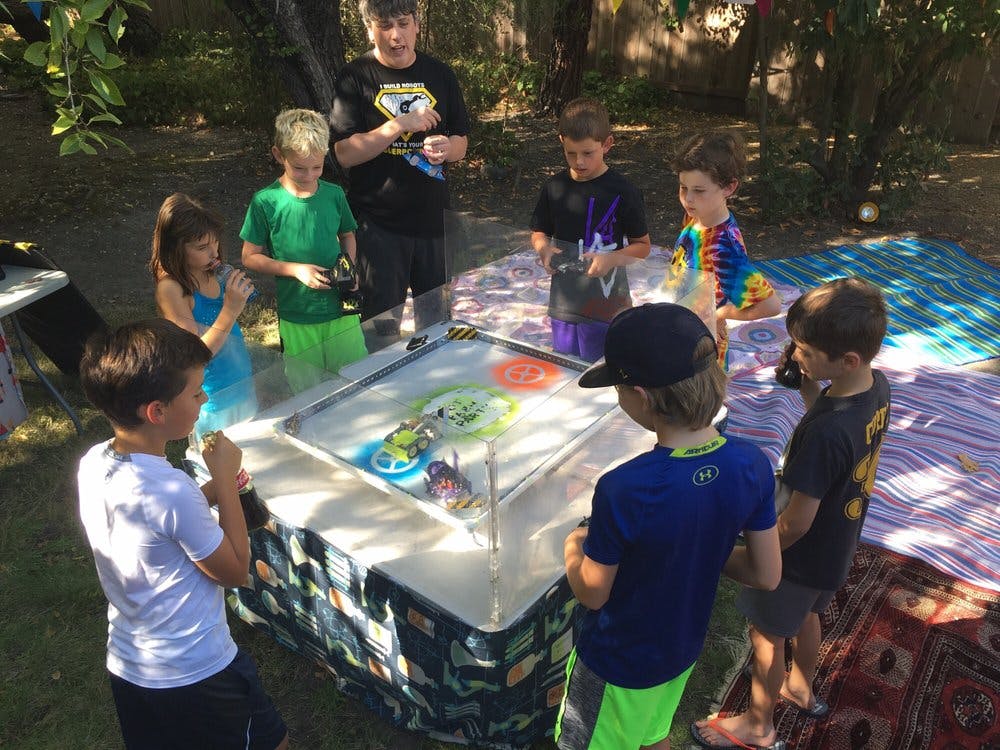 Children gathered around a table with a game