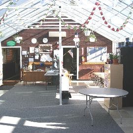 Interior of a greenhouse with a desk and tables