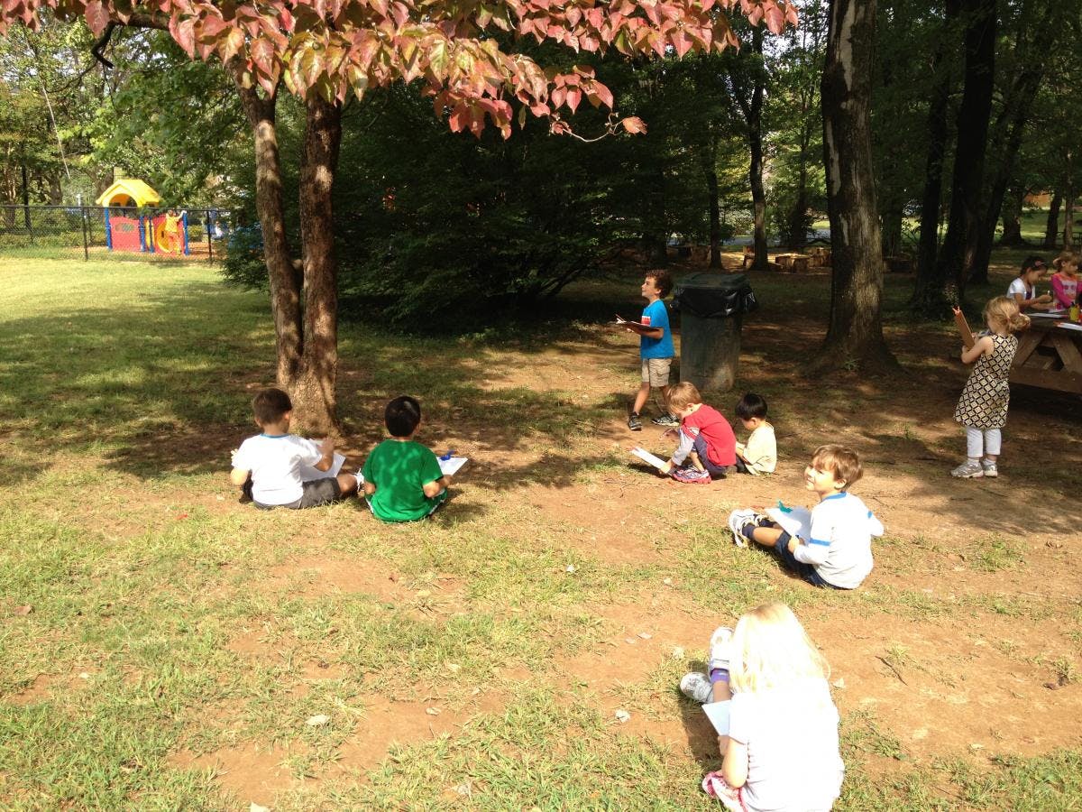 Children sitting on the ground outdoors