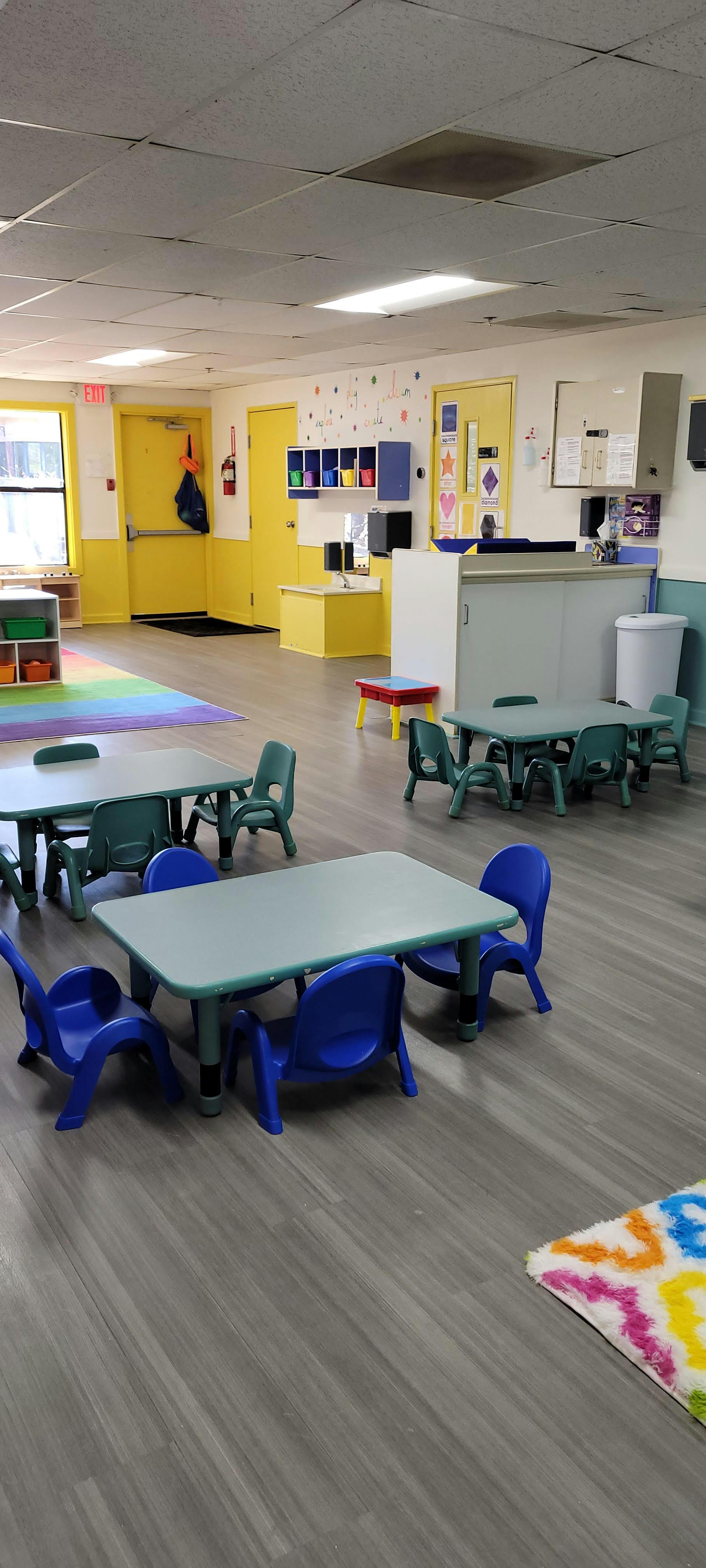 Empty classroom with small tables and chairs