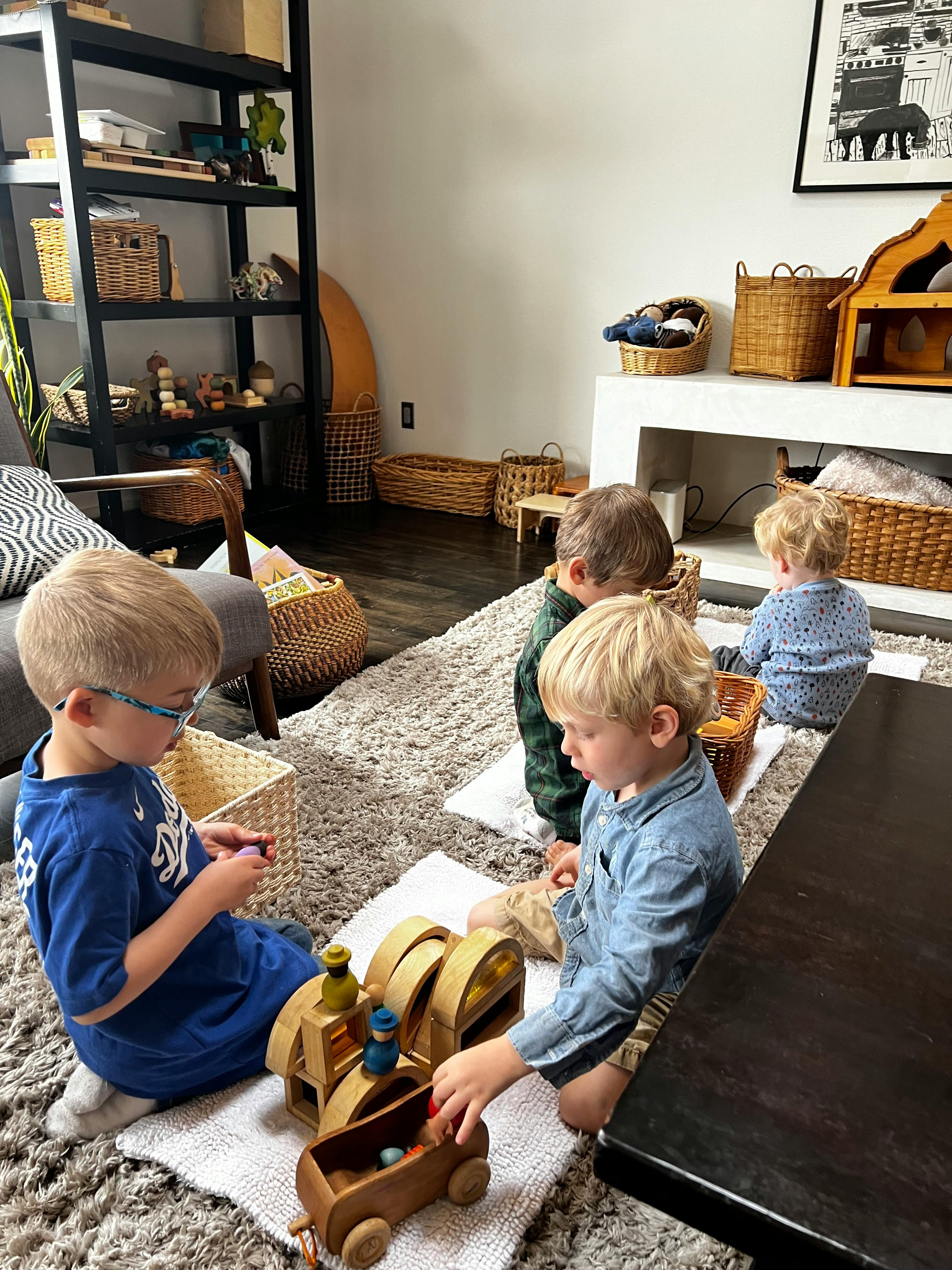 Children playing with wooden toys on a rug