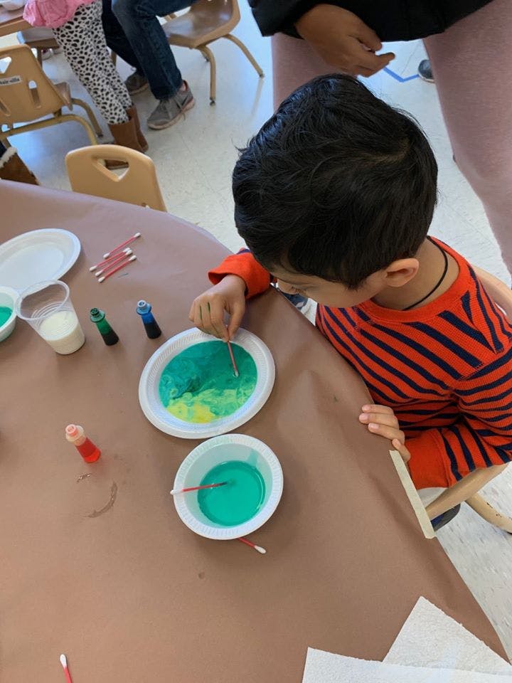 Child painting with cotton swabs