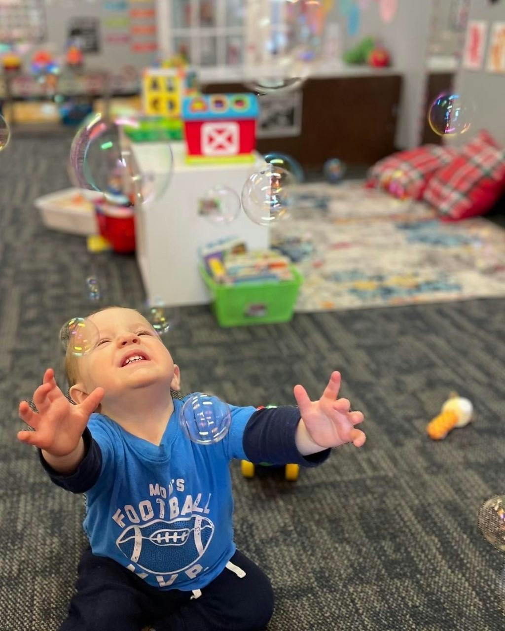Child reaching up at bubbles