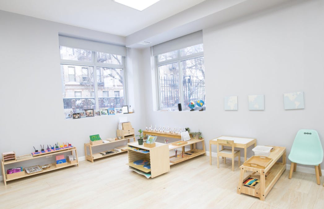 Classroom with wooden shelves, tables, and chairs