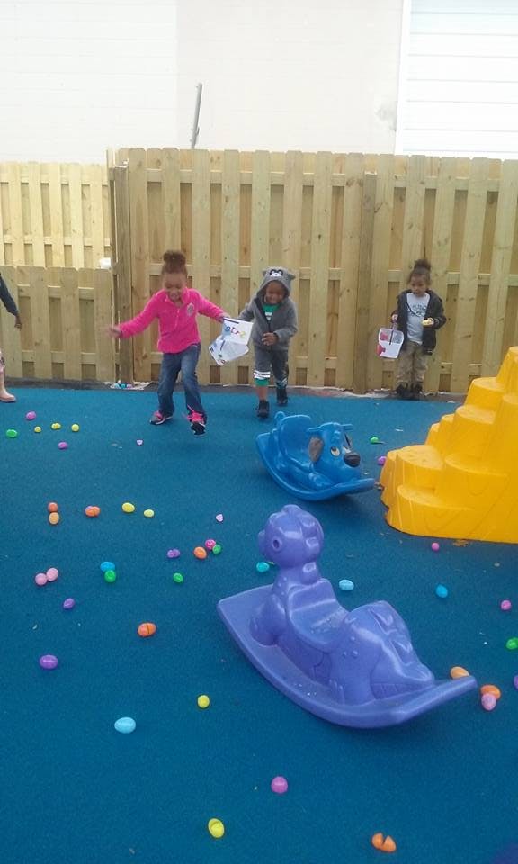 Children on a playground with colorful plastic eggs
