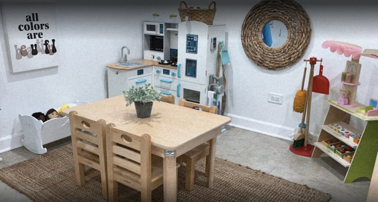 Playroom with small table and chairs, toy kitchen, and shelves