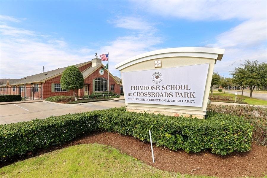Primrose School at Crossroads Park sign in front of a building