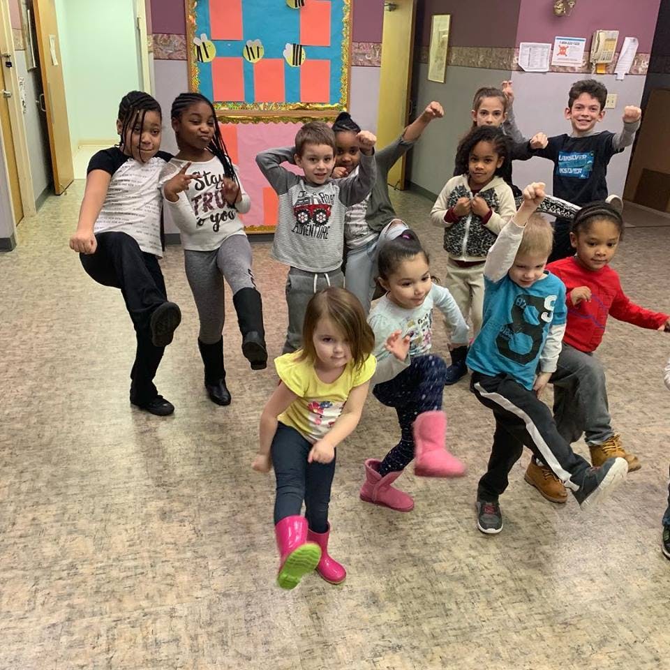 Group of children dancing and posing indoors