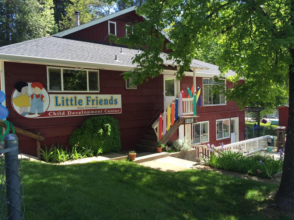 Red building with "Little Friends Child Development Center" sign