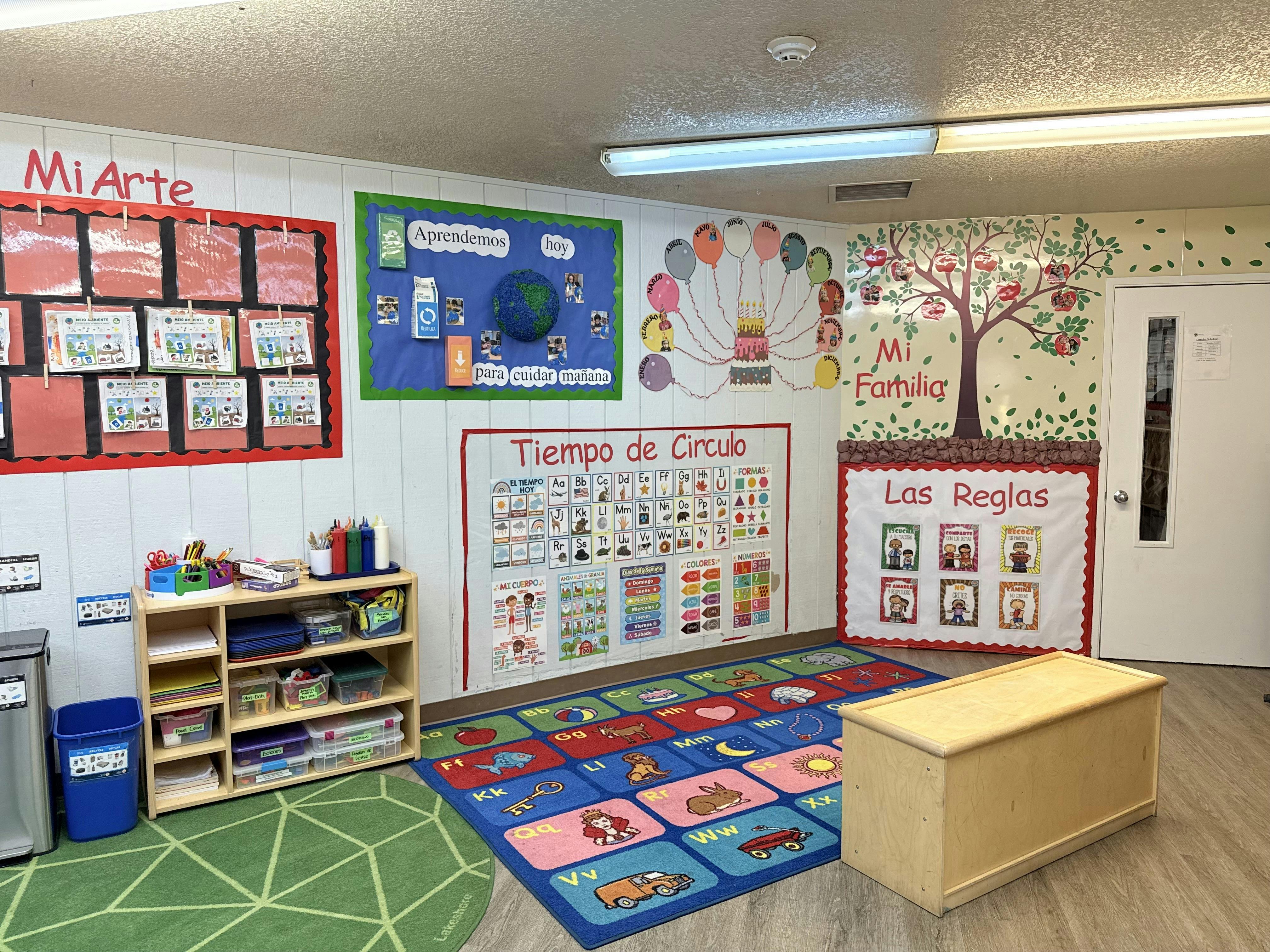Classroom interior with educational posters and a patterned rug