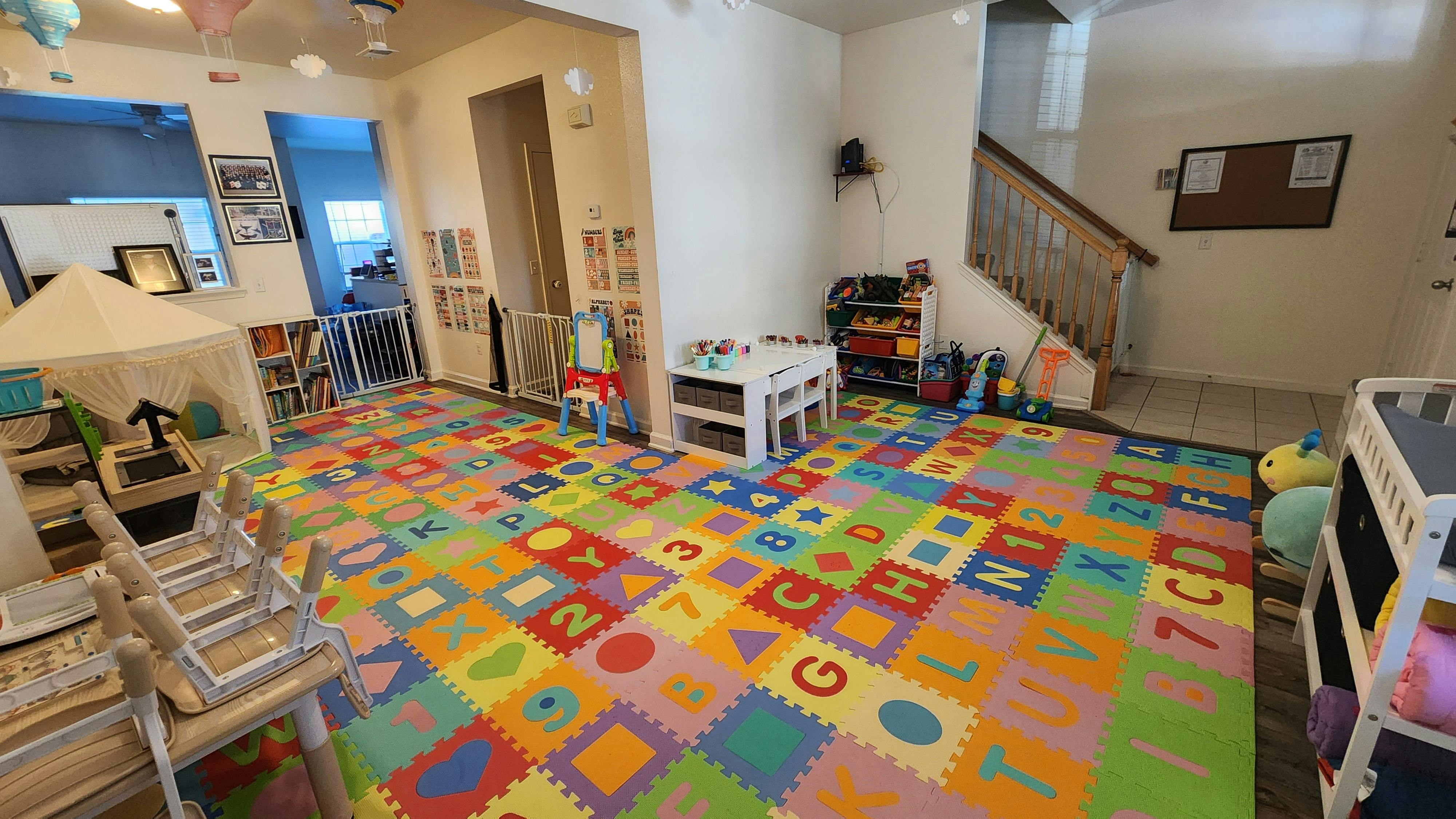 Playroom with colorful alphabet and number floor mats
