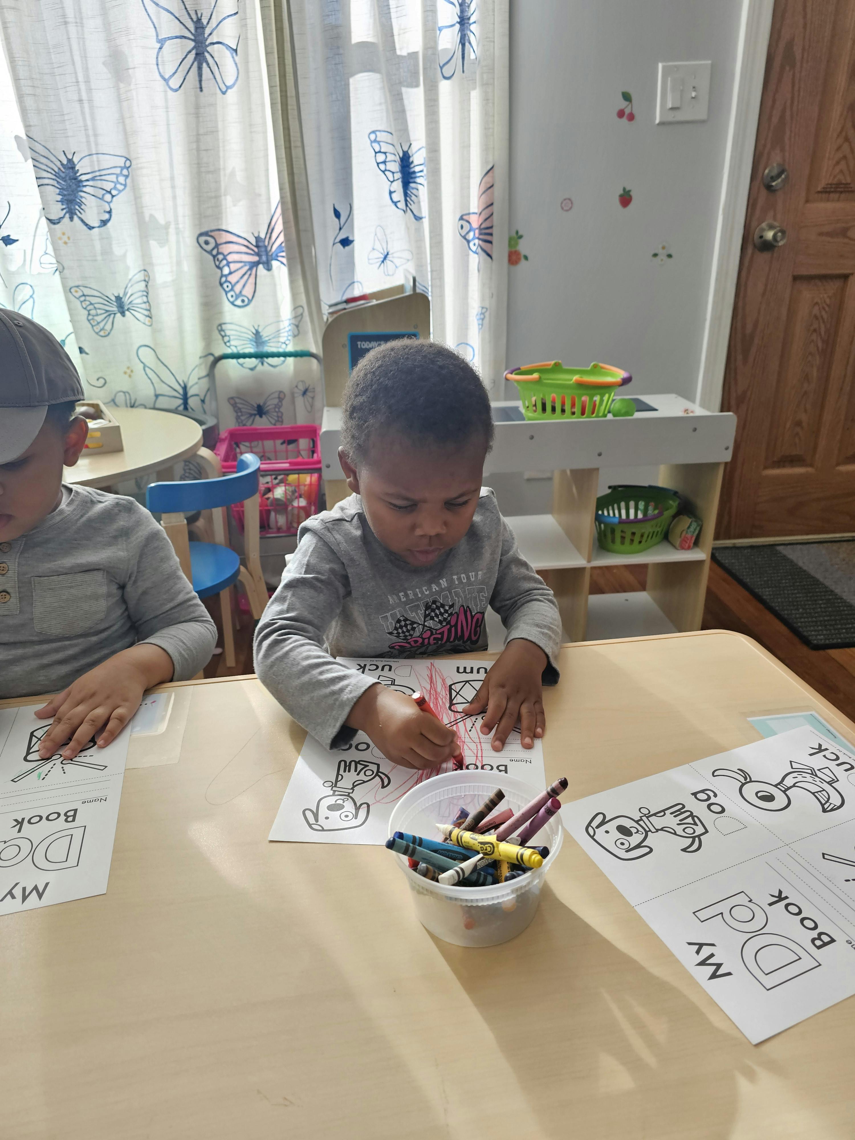 Two children coloring at a table