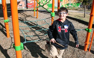 Child standing on playground equipment
