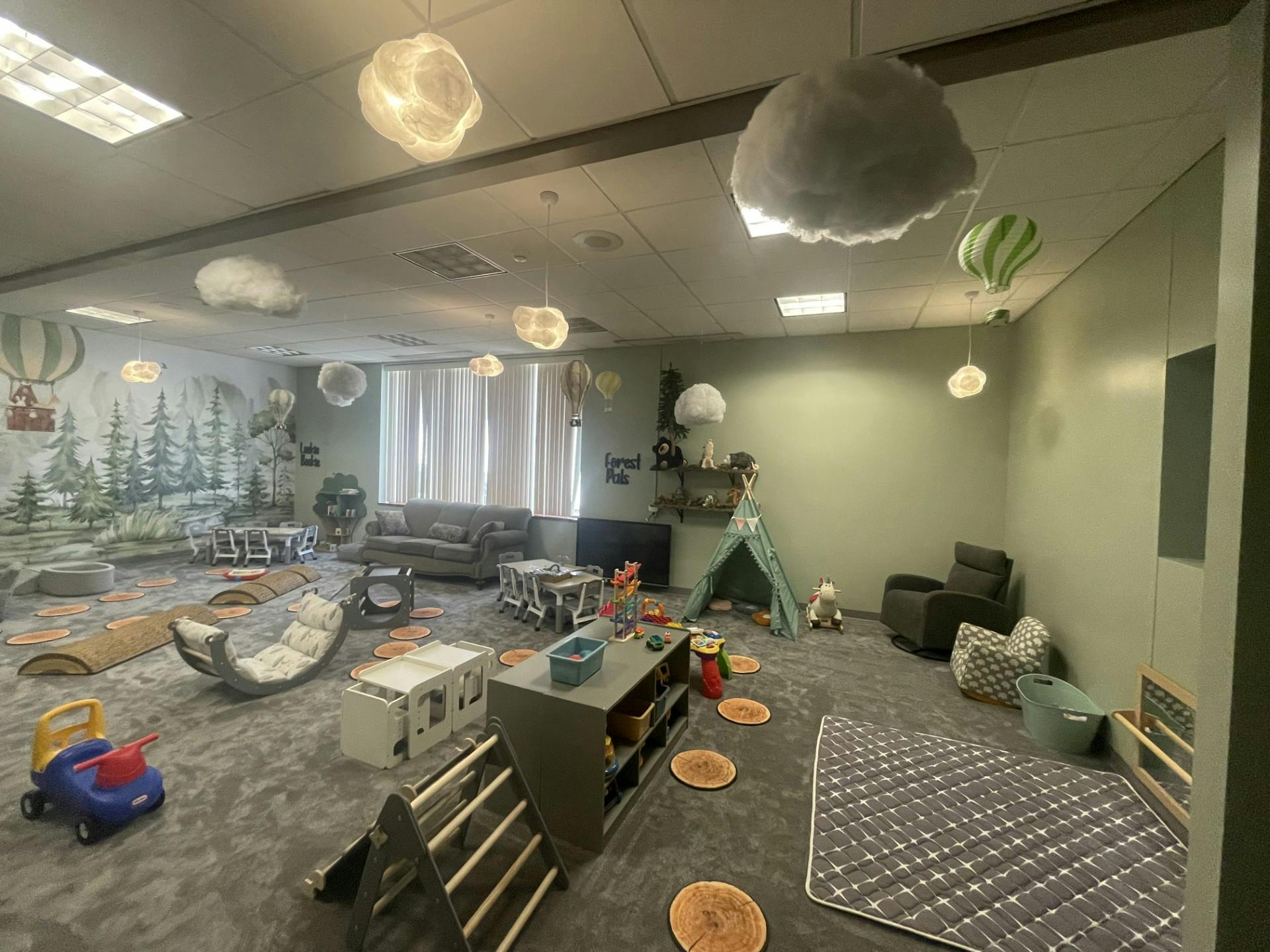 Children's play area with various toys and furniture