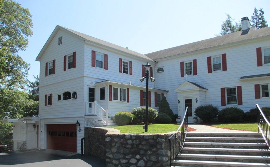 White house with red shutters and a red garage door
