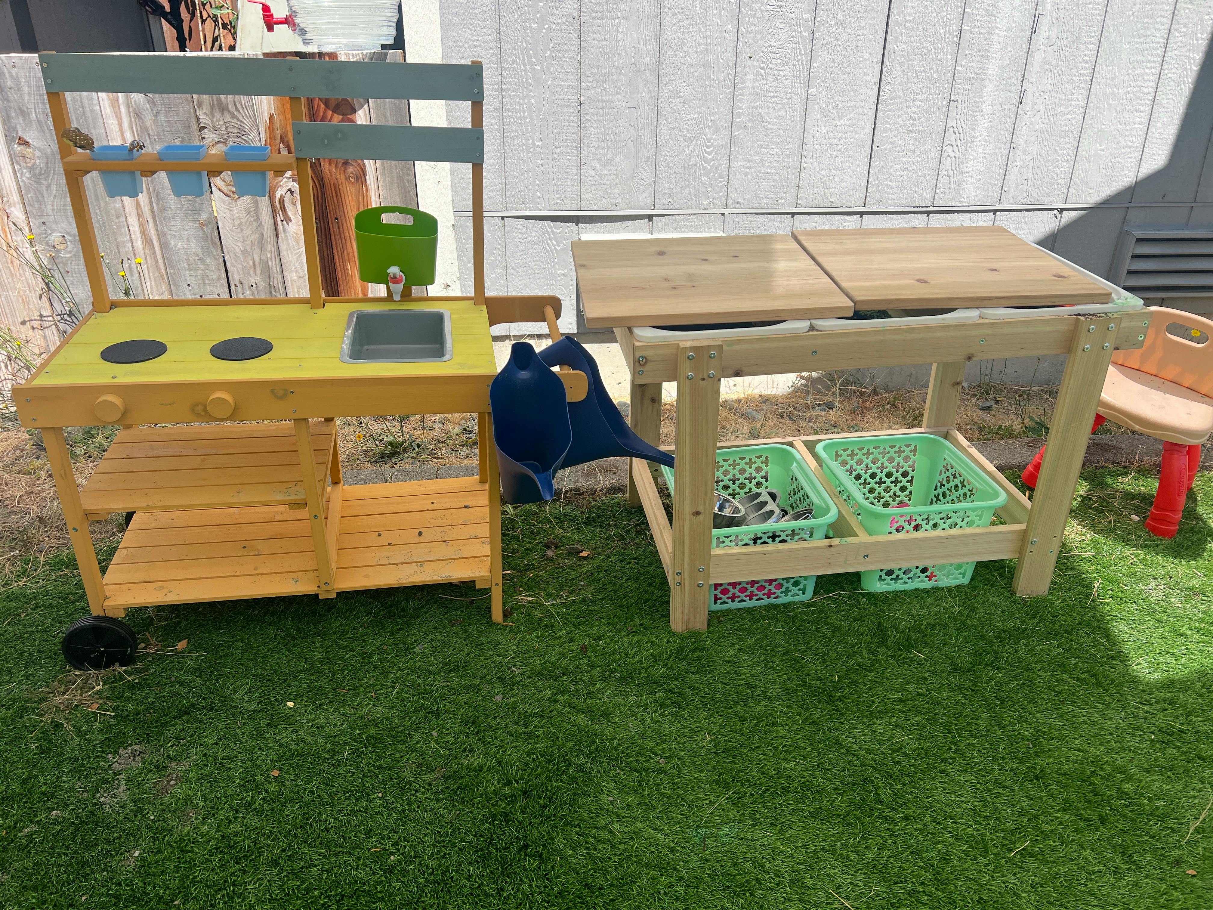 Wooden outdoor toy kitchen and sensory table on artificial grass