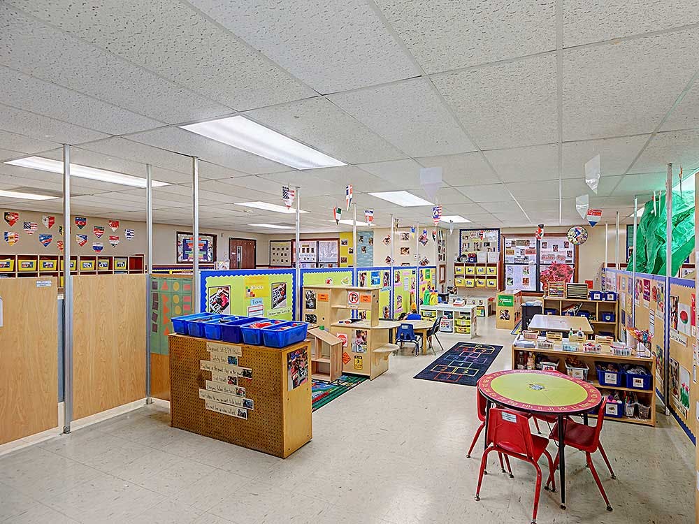 Classroom with dividers, small tables, and educational materials