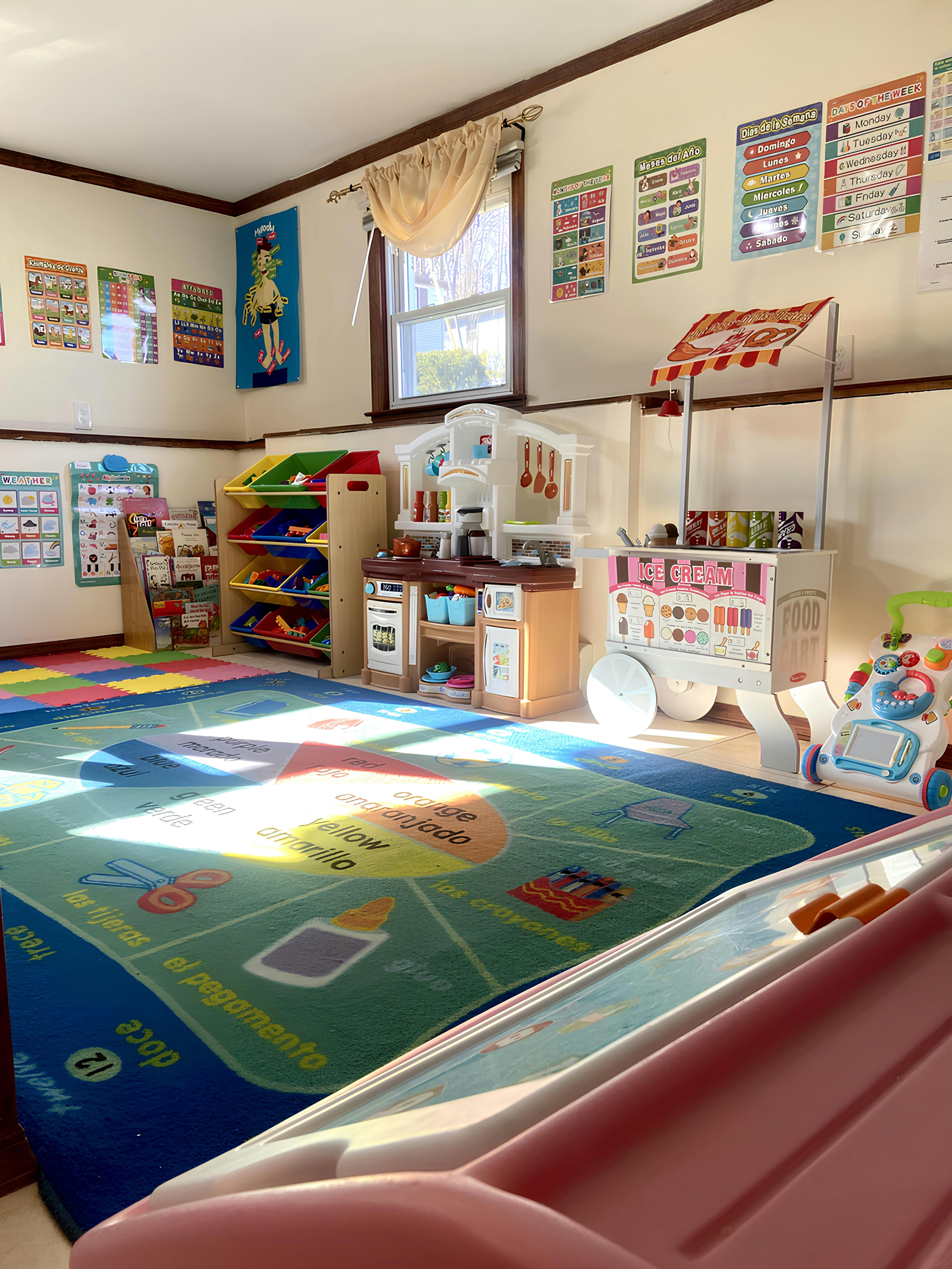 Playroom with a colorful rug, toy kitchen, and ice cream cart