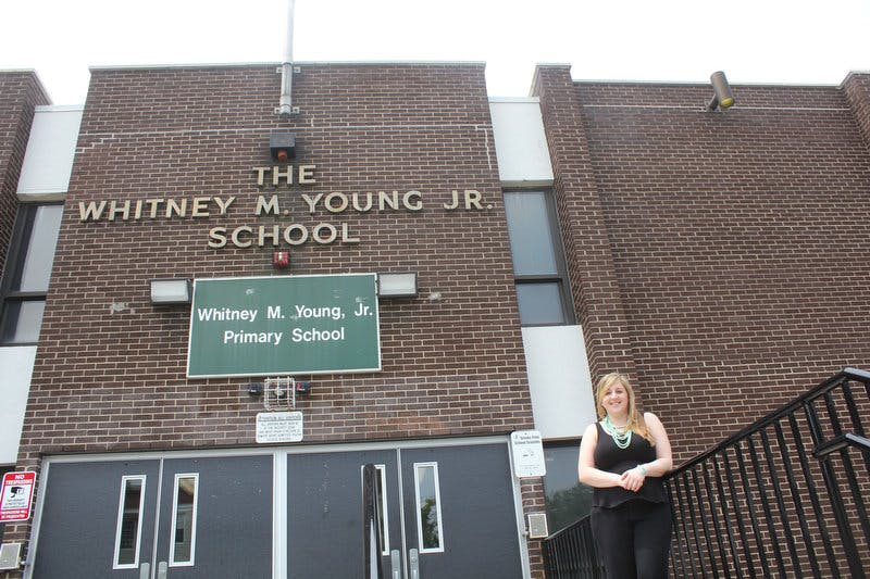 Person standing in front of The Whitney M. Young Jr. School