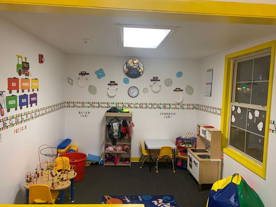 Playroom with small tables, chairs, and toys