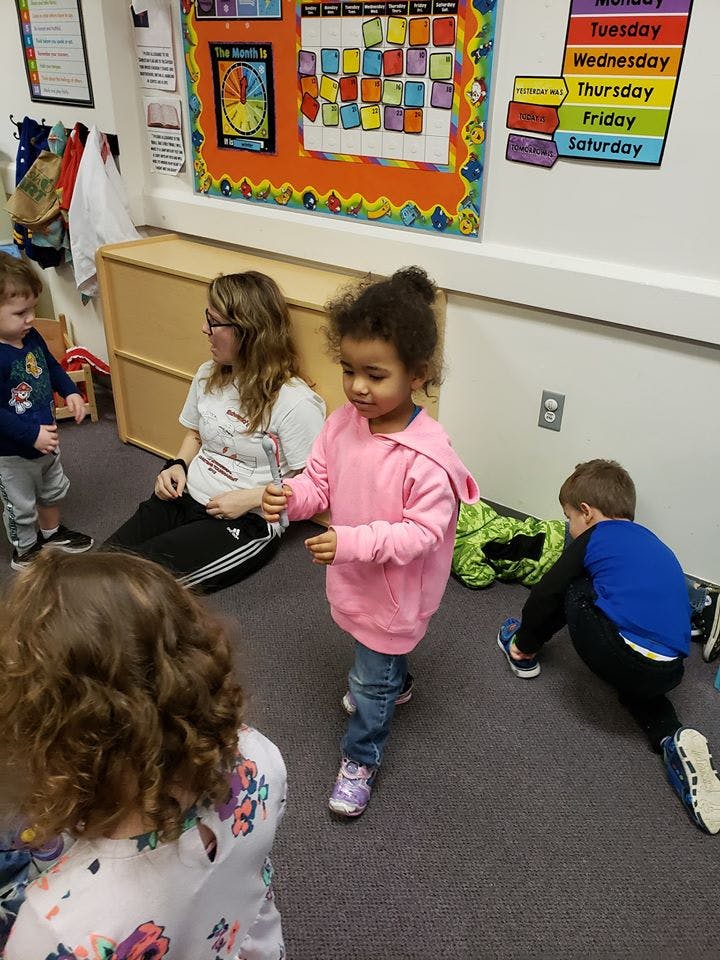 Adult and children in a classroom