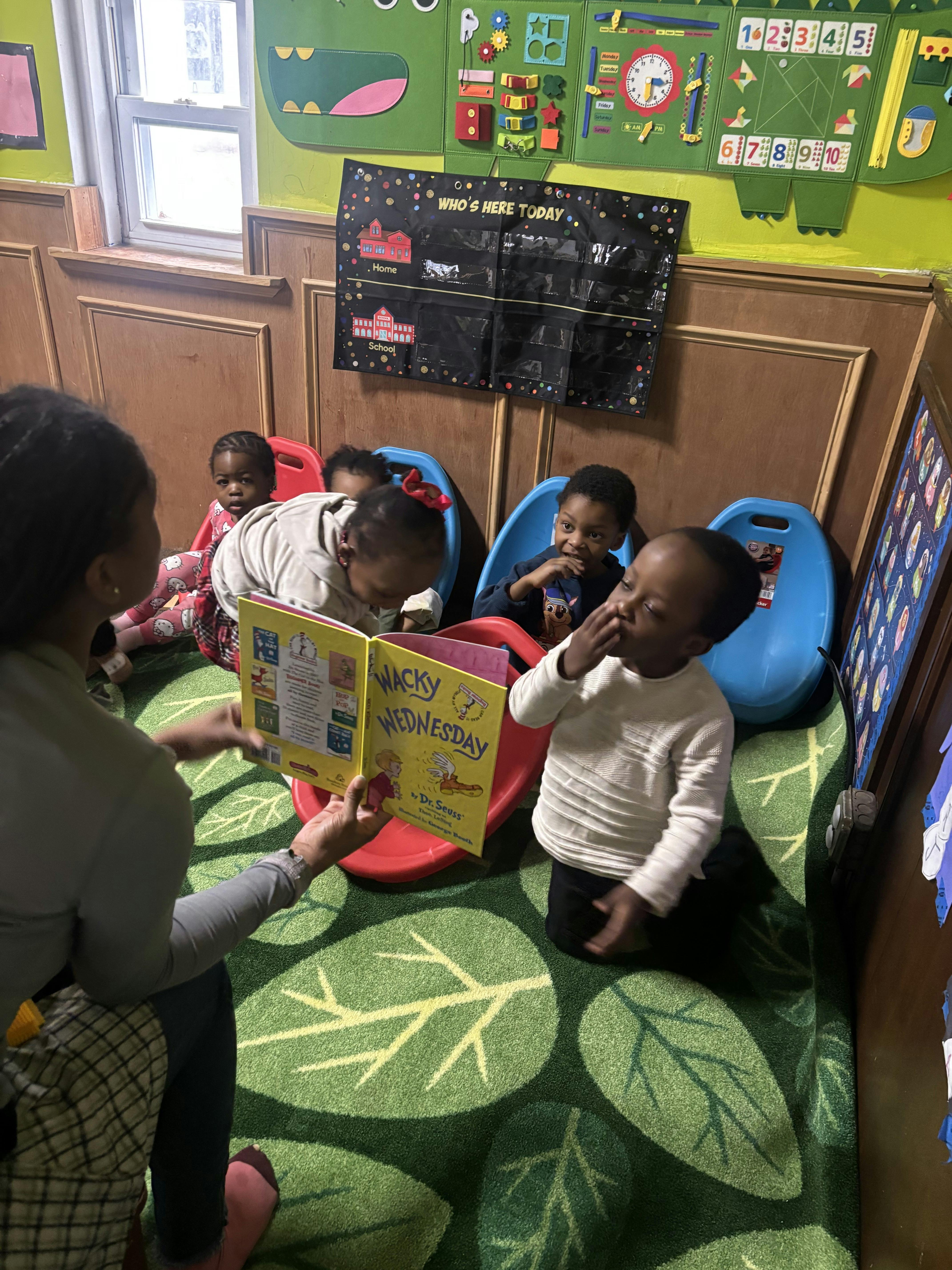 Person reading Wacky Wednesday to a group of children in a classroom