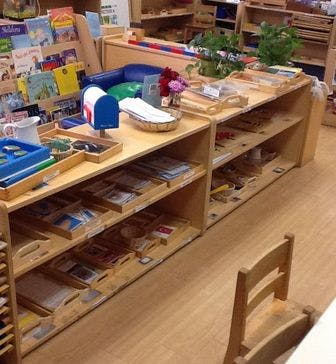 Montessori classroom with wooden shelves and learning materials