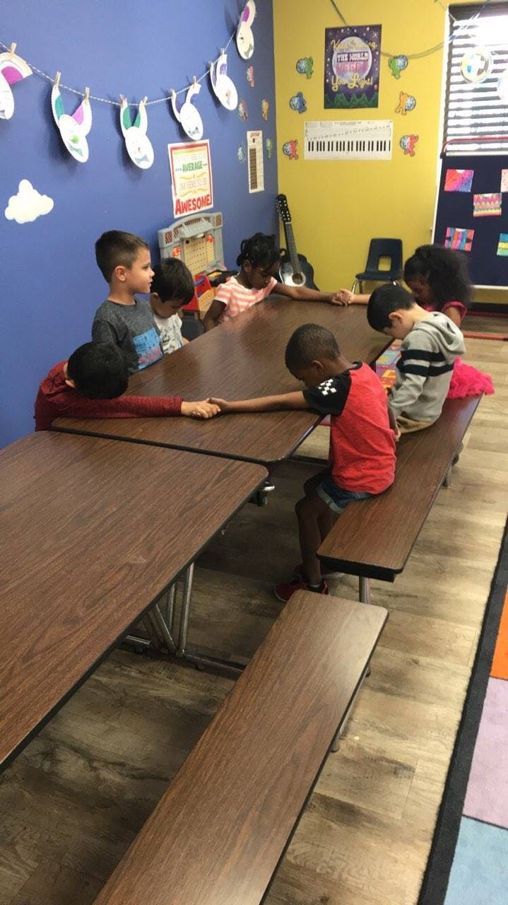 Children sitting at tables in a classroom
