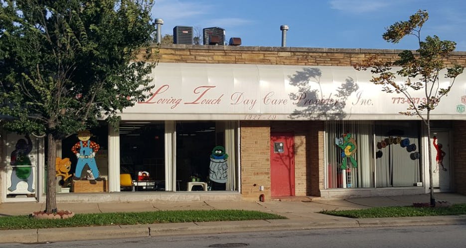 Storefront with "Loving Touch Day Care" sign