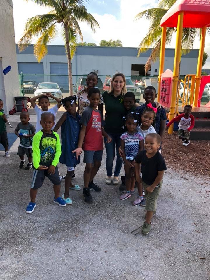 Adult person with a group of children outdoors