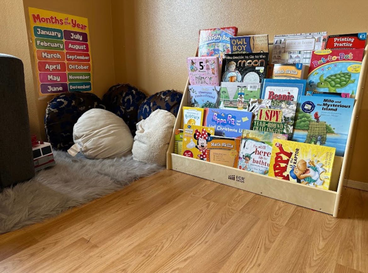 Children's book display and floor cushions in a reading nook