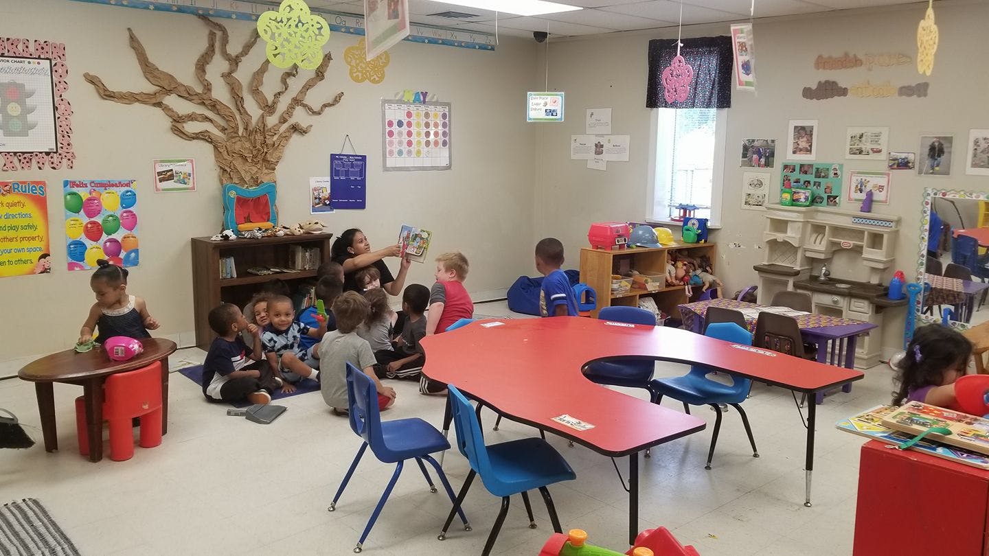 Person reading to children in a classroom