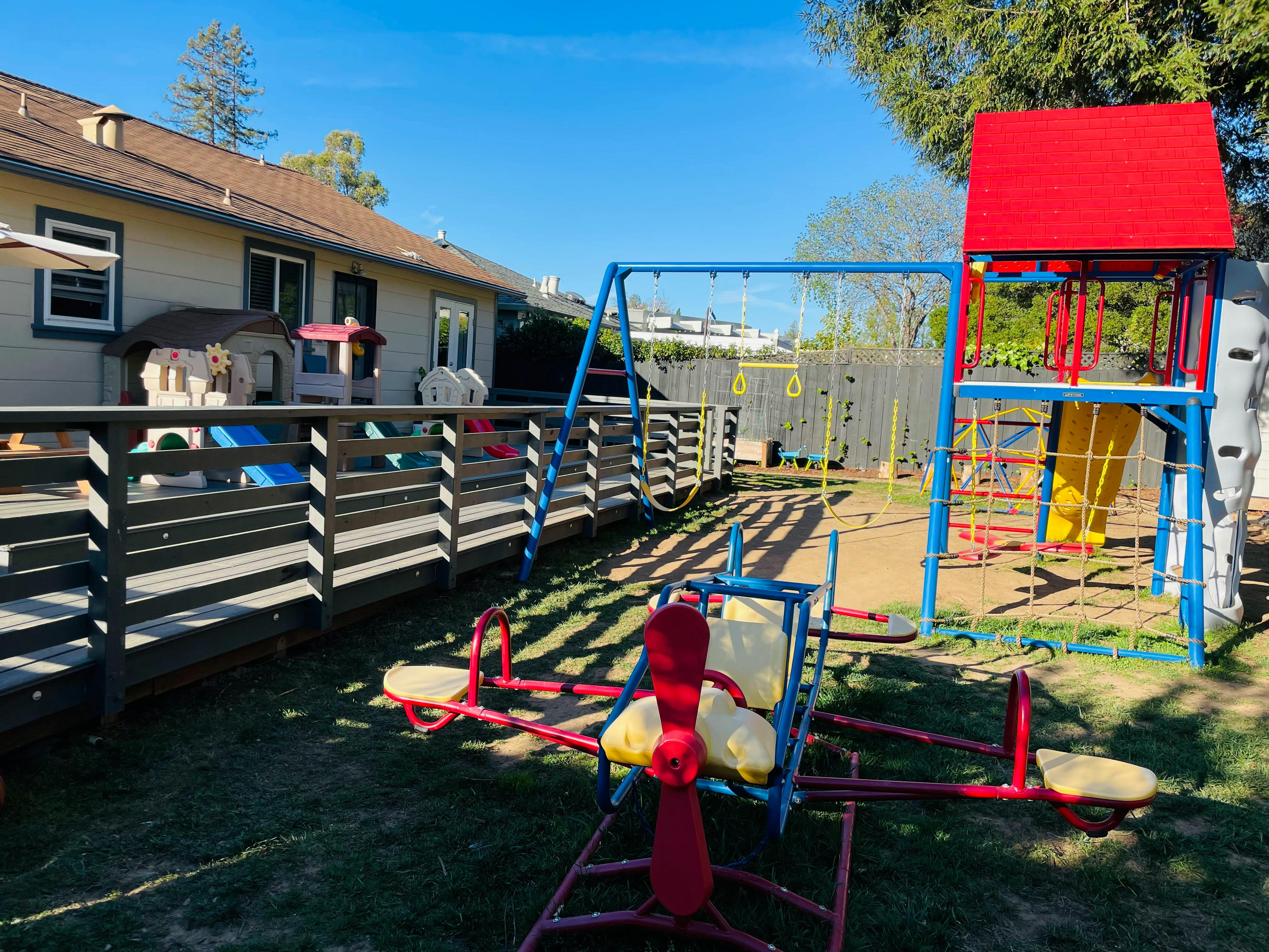 Playground with a swing set, slide, and seesaw